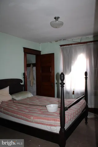 a bathroom with a toilet a sink and a window