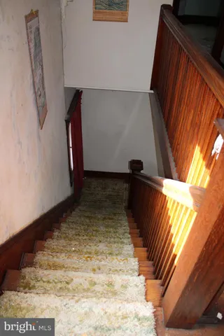 a bathroom with a granite countertop toilet a sink and a shower