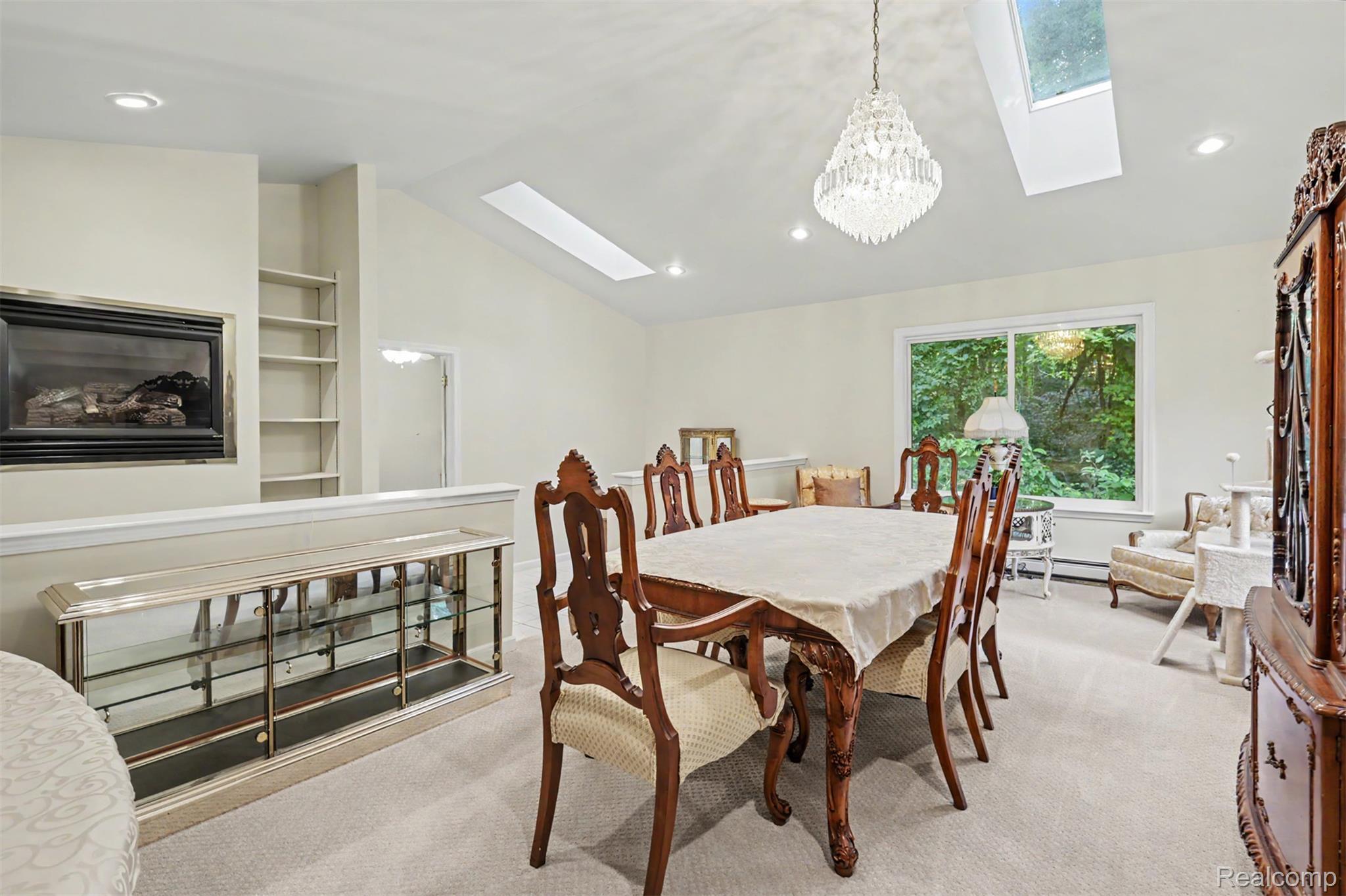 45223 Wear Road Belleville, MI 48111 - Photo 29 of 60 Recessed lighting, skylights, built-in shelving, and a wall-mounted fireplace