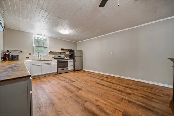 a kitchen with granite countertop a sink and stainless steel appliances