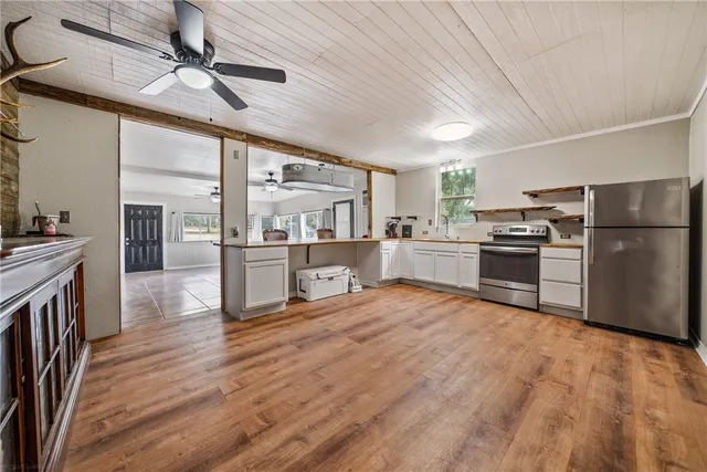 a kitchen with stainless steel appliances granite countertop a refrigerator and a stove top oven