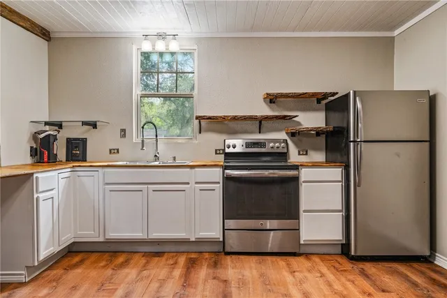 a kitchen with a refrigerator and a sink