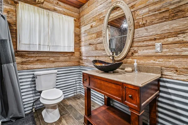 a bathroom with a toilet a sink and a mirror