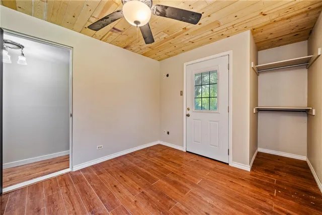 a view of room with wooden floor and lounge chair
