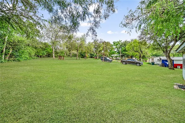 a view of a field of grass and trees