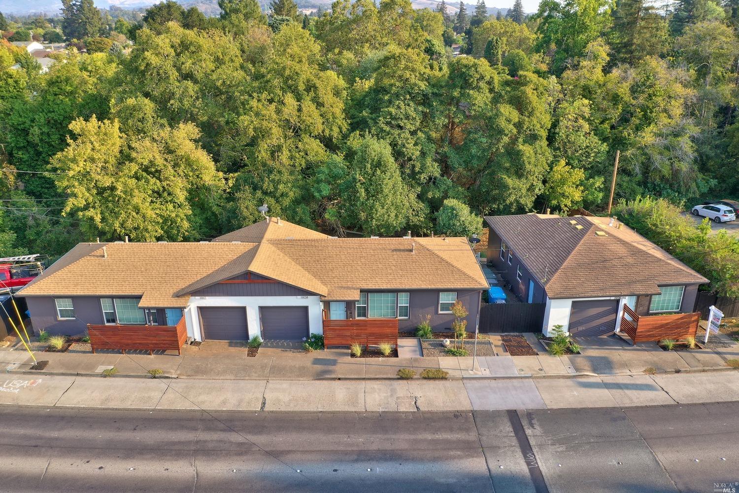 a aerial view of a house with a yard and balcony