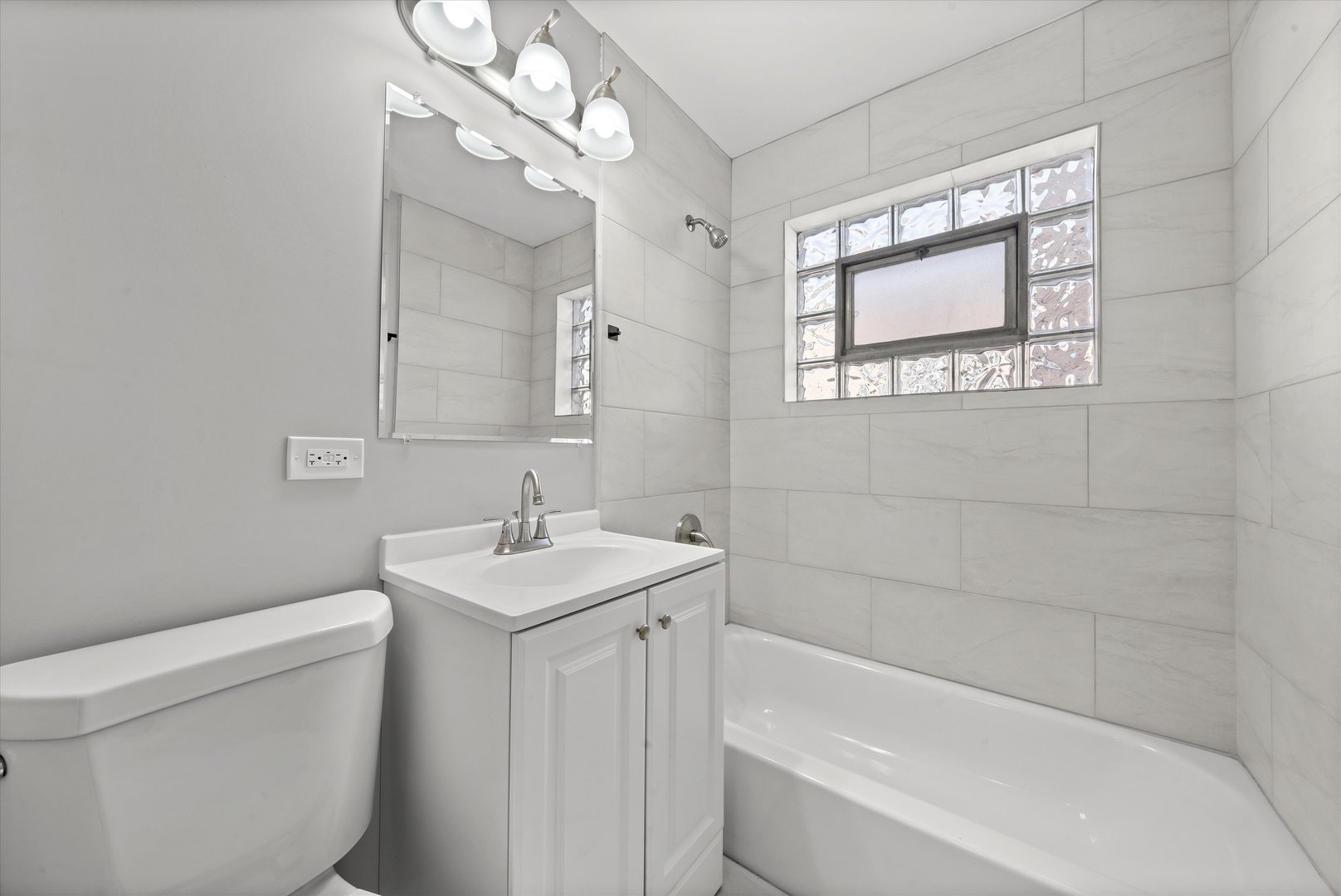 10344 South State Street Chicago, IL 60628 - Photo 28 of 30 a bathroom with a sink a toilet and shower