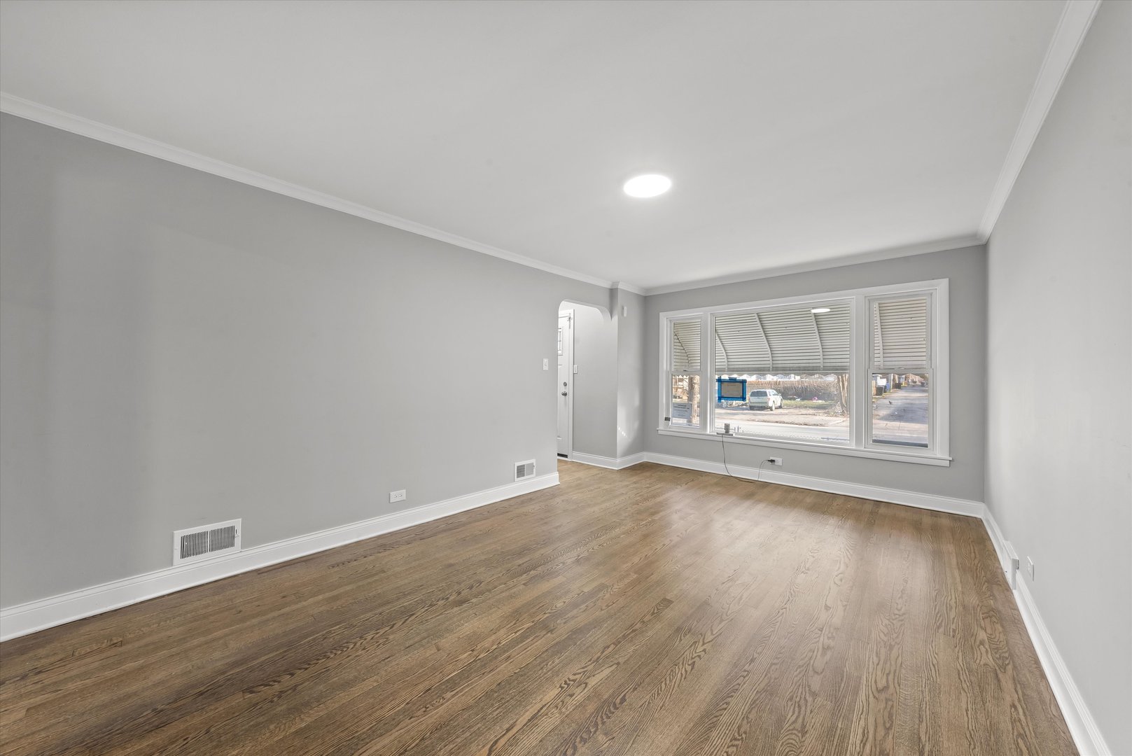 10344 South State Street Chicago, IL 60628 - Photo 3 of 30 a view of a hardwood floor in a room with a window