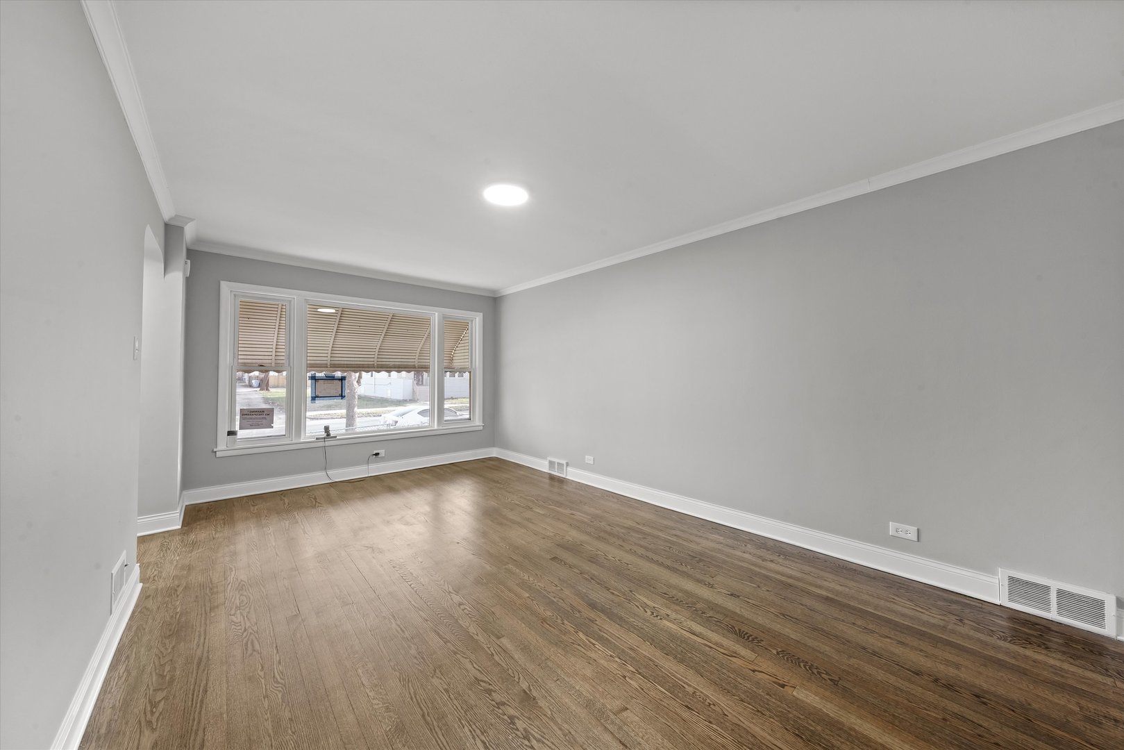 10344 South State Street Chicago, IL 60628 - Photo 4 of 30 a view of a room with wooden floor and a window