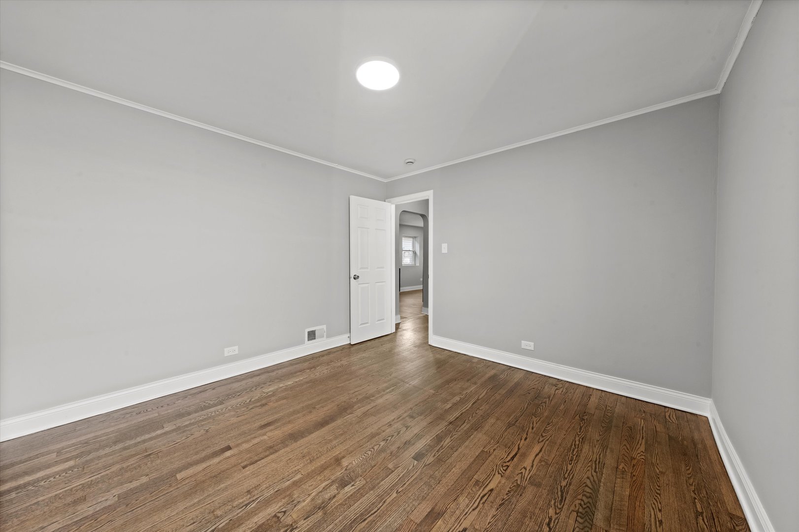 10344 South State Street Chicago, IL 60628 - Photo 5 of 30 a view of an empty room with wooden floor