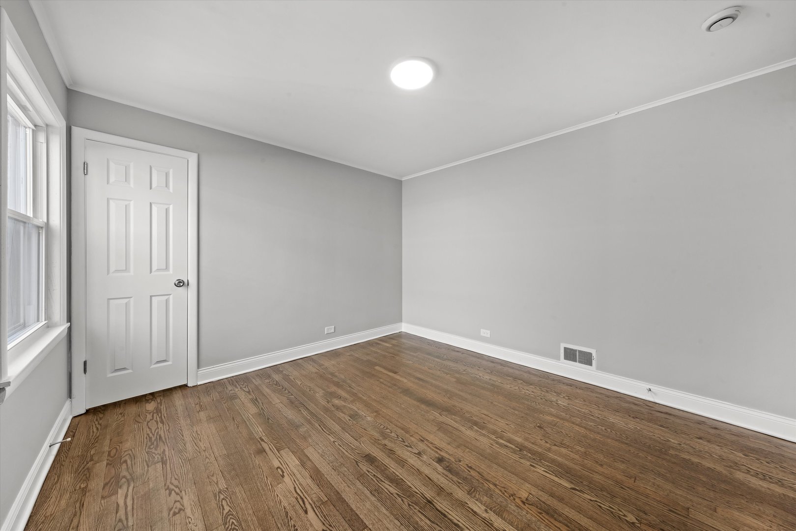 10344 South State Street Chicago, IL 60628 - Photo 6 of 30 a view of an empty room with wooden floor