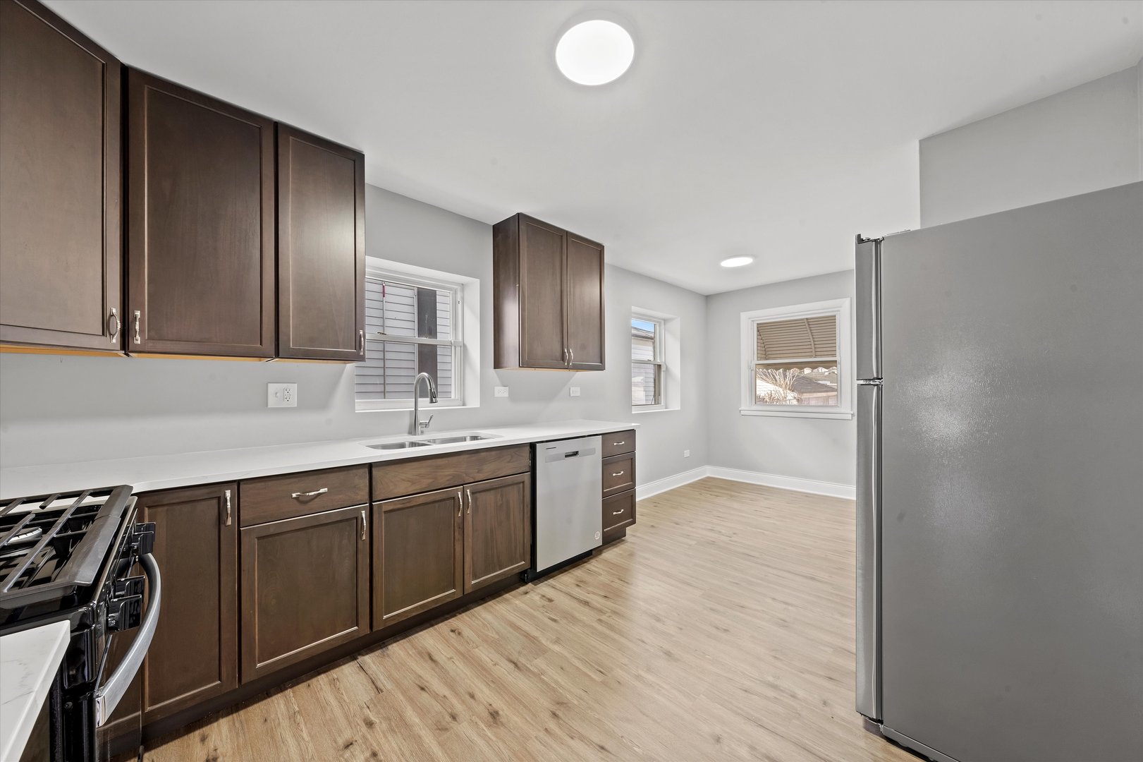 10344 South State Street Chicago, IL 60628 - Photo 10 of 30 a large bathroom with a double vanity sink and a mirror