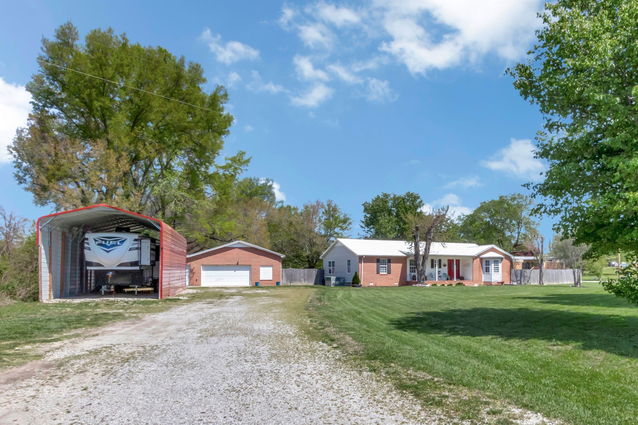 2643 Monroe Floyd Road Decherd, TN 37324 - Photo 4 of 42 a view of a big yard with large trees and a small barn