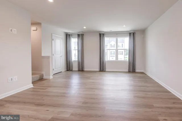 a bathroom with a toilet a sink a vanity and mirror