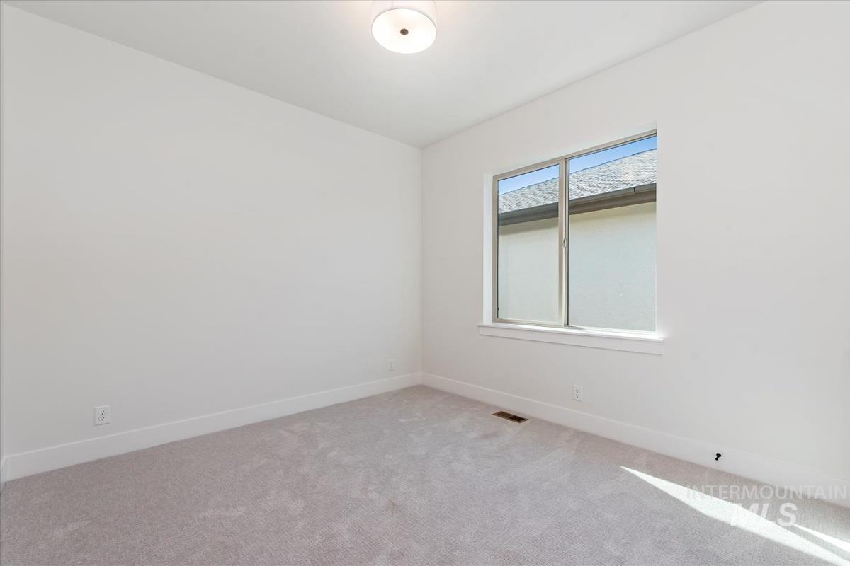 2242 East Rodeo Street Kuna, ID 83634 - Photo 19 of 37 Carpeted spare room featuring baseboards