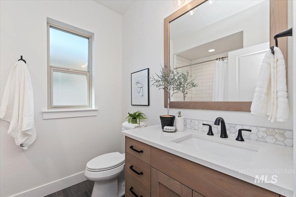 2242 East Rodeo Street Kuna, ID 83634 - Photo 20 of 37 Bathroom featuring vanity, a shower with curtain, and dark wood-style floors