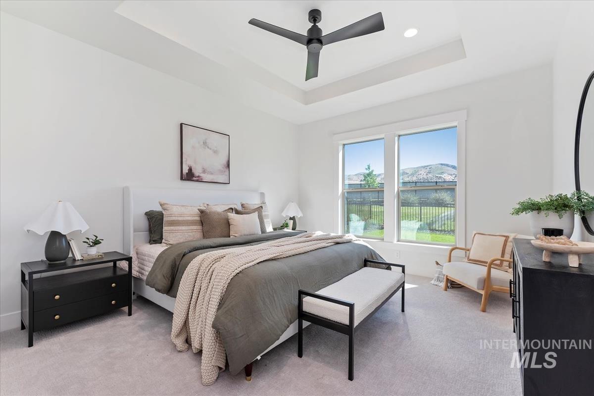 2242 East Rodeo Street Kuna, ID 83634 - Photo 24 of 37 Bedroom featuring a raised ceiling, ceiling fan, and light carpet