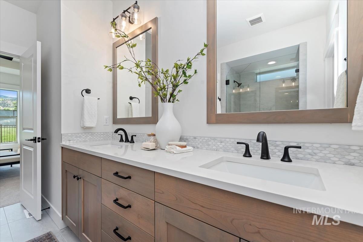 2242 East Rodeo Street Kuna, ID 83634 - Photo 28 of 37 Bathroom with double vanity, a shower stall, and light tile patterned flooring