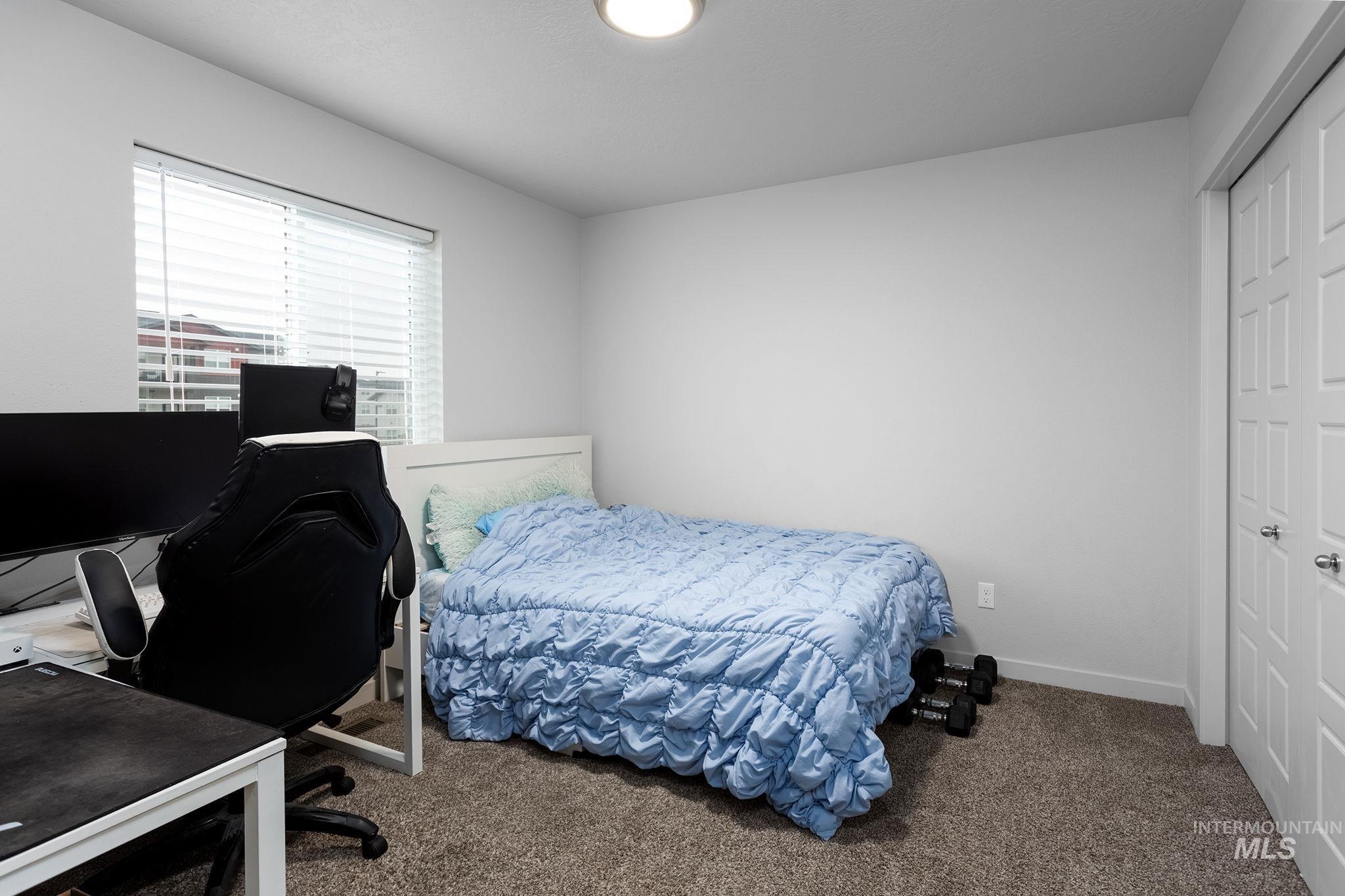 262 South Riggs Spg Avenue Meridian, ID 83642 - Photo 14 of 25 Carpeted bedroom featuring a desk and baseboards