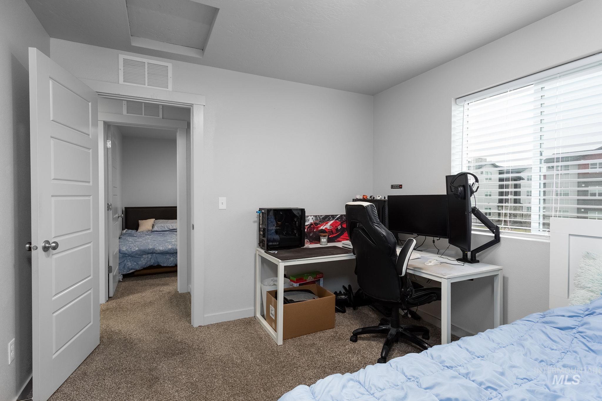 262 South Riggs Spg Avenue Meridian, ID 83642 - Photo 15 of 25 Carpeted bedroom featuring an office area and attic access