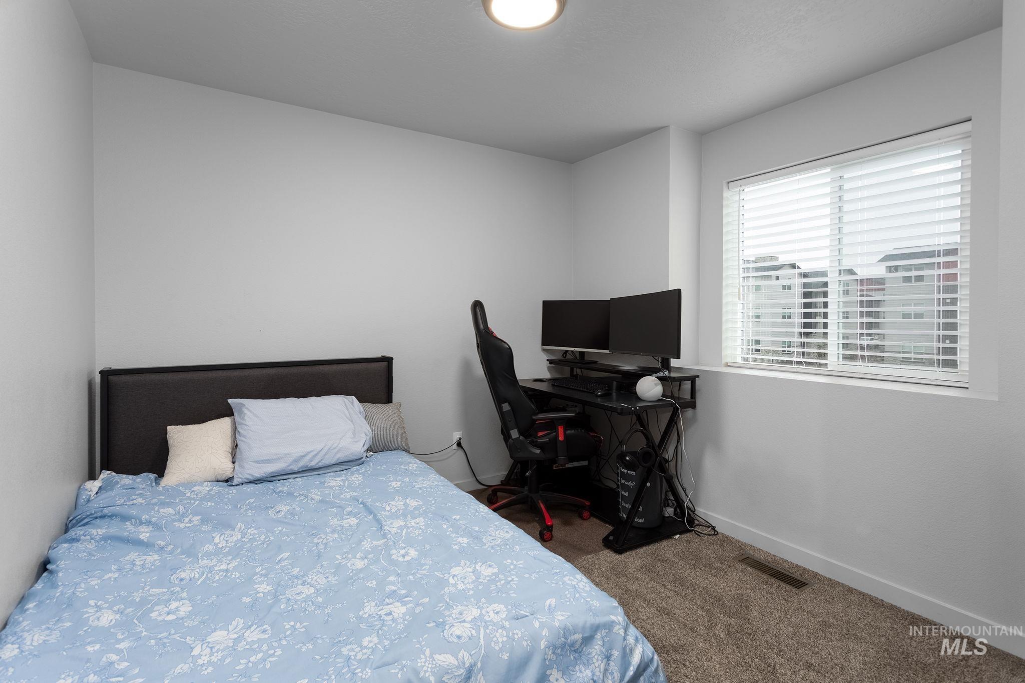 262 South Riggs Spg Avenue Meridian, ID 83642 - Photo 16 of 25 Carpeted bedroom featuring baseboards and a desk