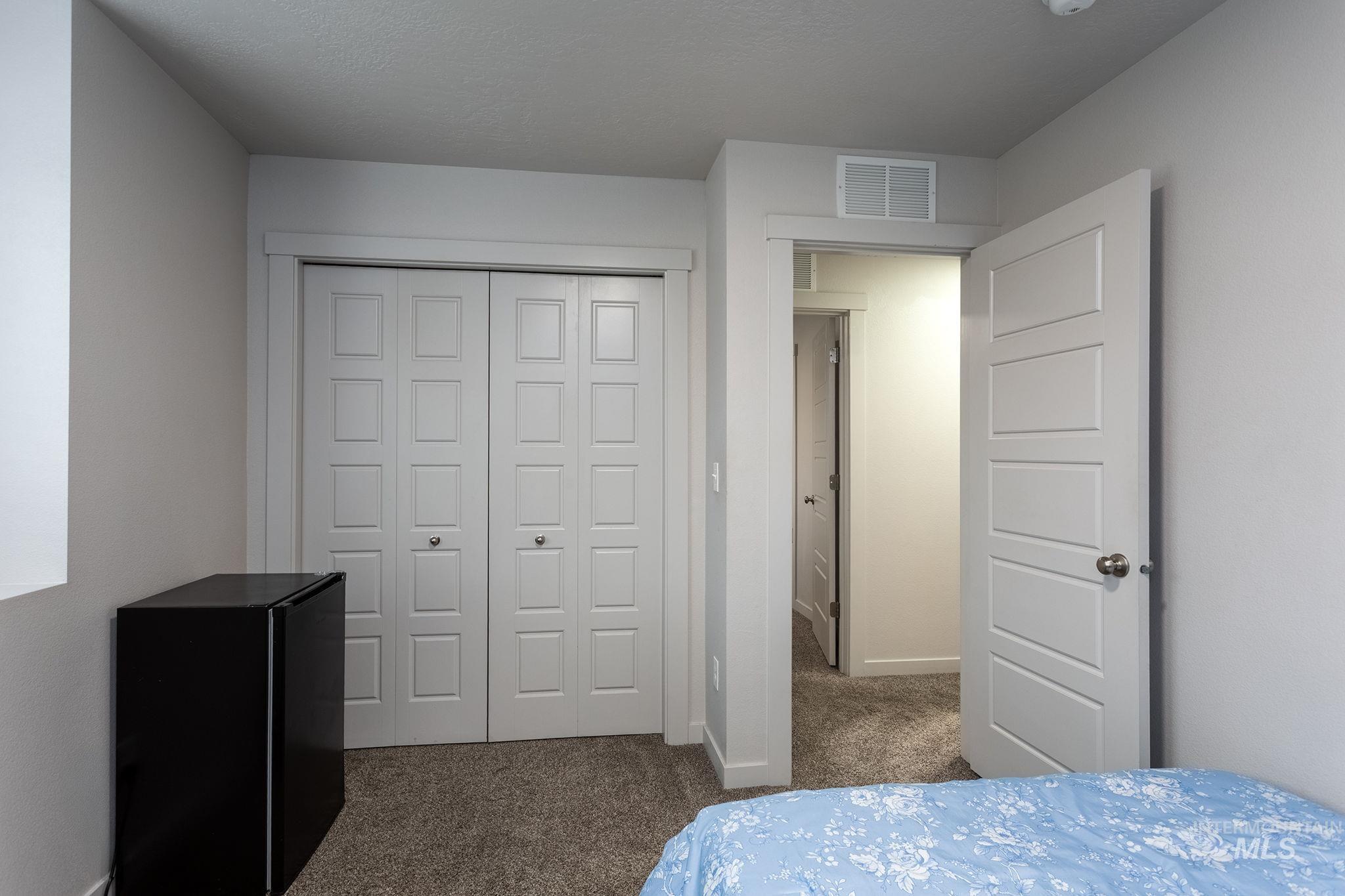 262 South Riggs Spg Avenue Meridian, ID 83642 - Photo 17 of 25 Bedroom featuring dark colored carpet and a closet