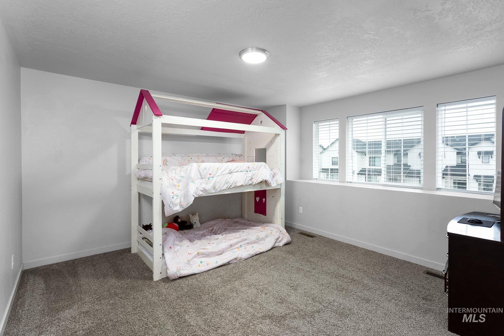 262 South Riggs Spg Avenue Meridian, ID 83642 - Photo 18 of 25 Bedroom with a textured ceiling and carpet flooring