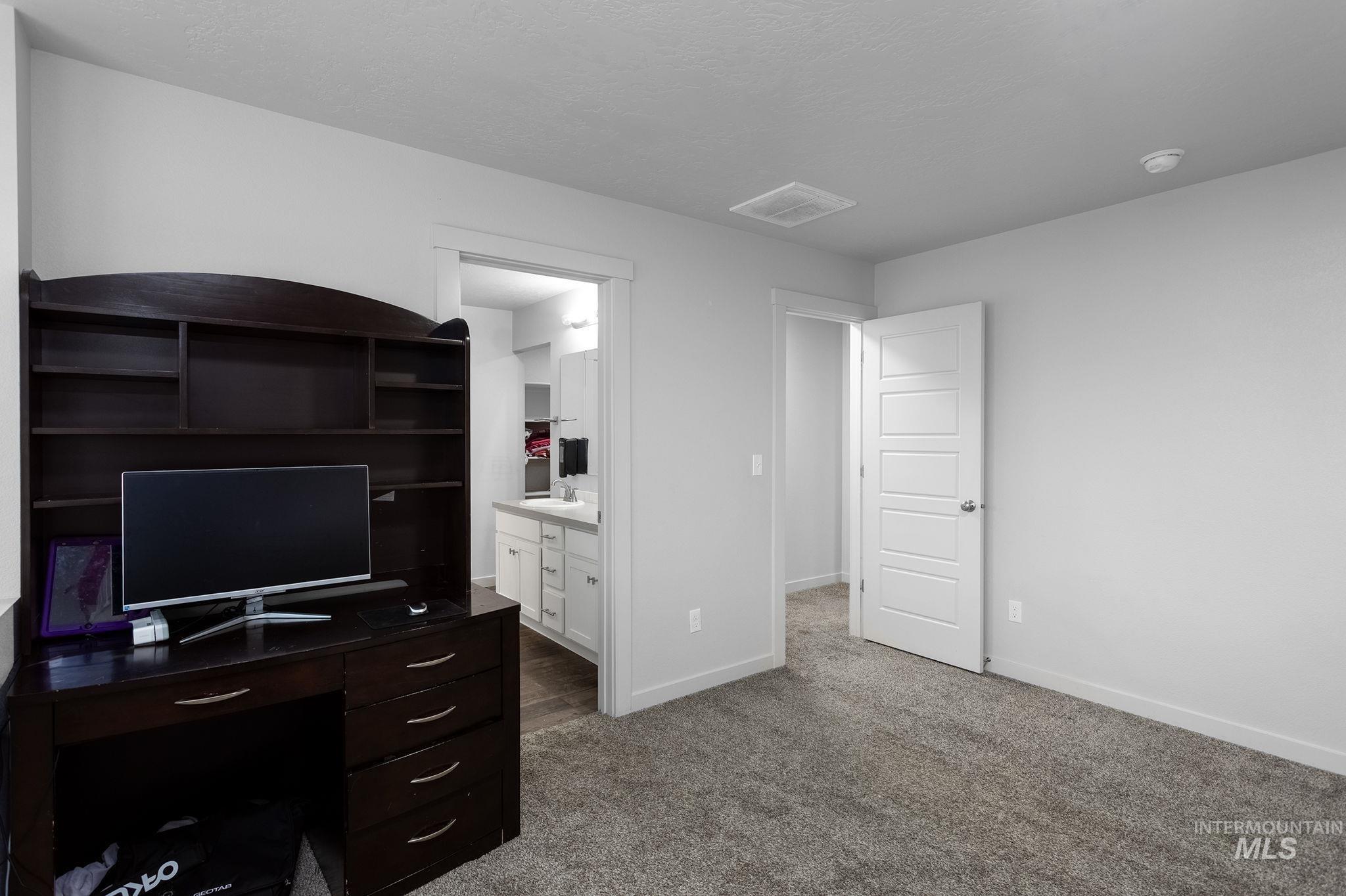 262 South Riggs Spg Avenue Meridian, ID 83642 - Photo 19 of 25 Unfurnished office with dark carpet and a textured ceiling