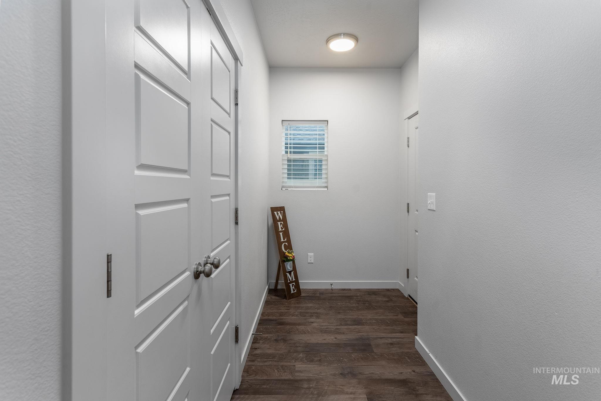262 South Riggs Spg Avenue Meridian, ID 83642 - Photo 3 of 25 Hall featuring baseboards and dark wood-style floors