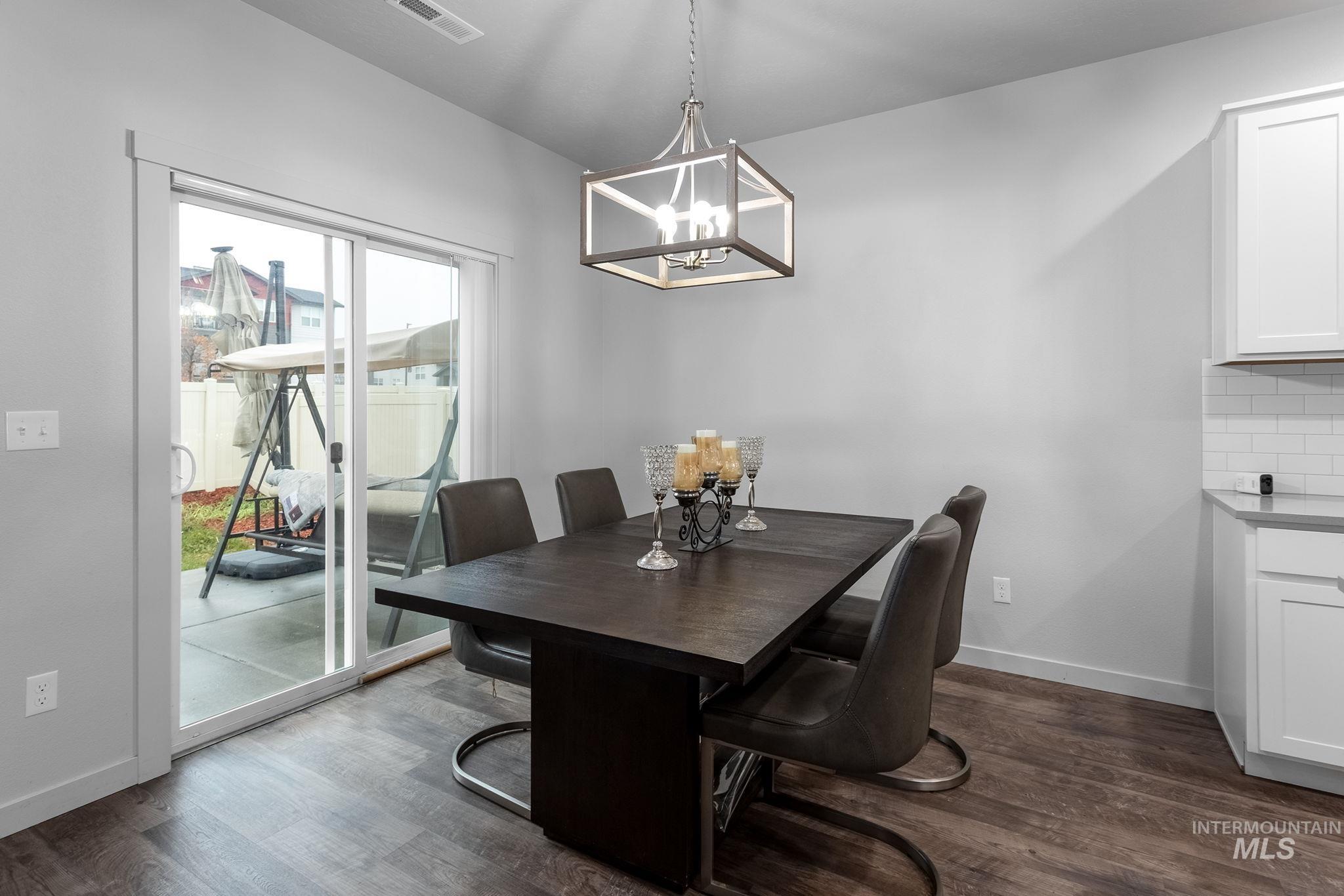 262 South Riggs Spg Avenue Meridian, ID 83642 - Photo 5 of 25 Dining room with dark wood-type flooring and a chandelier
