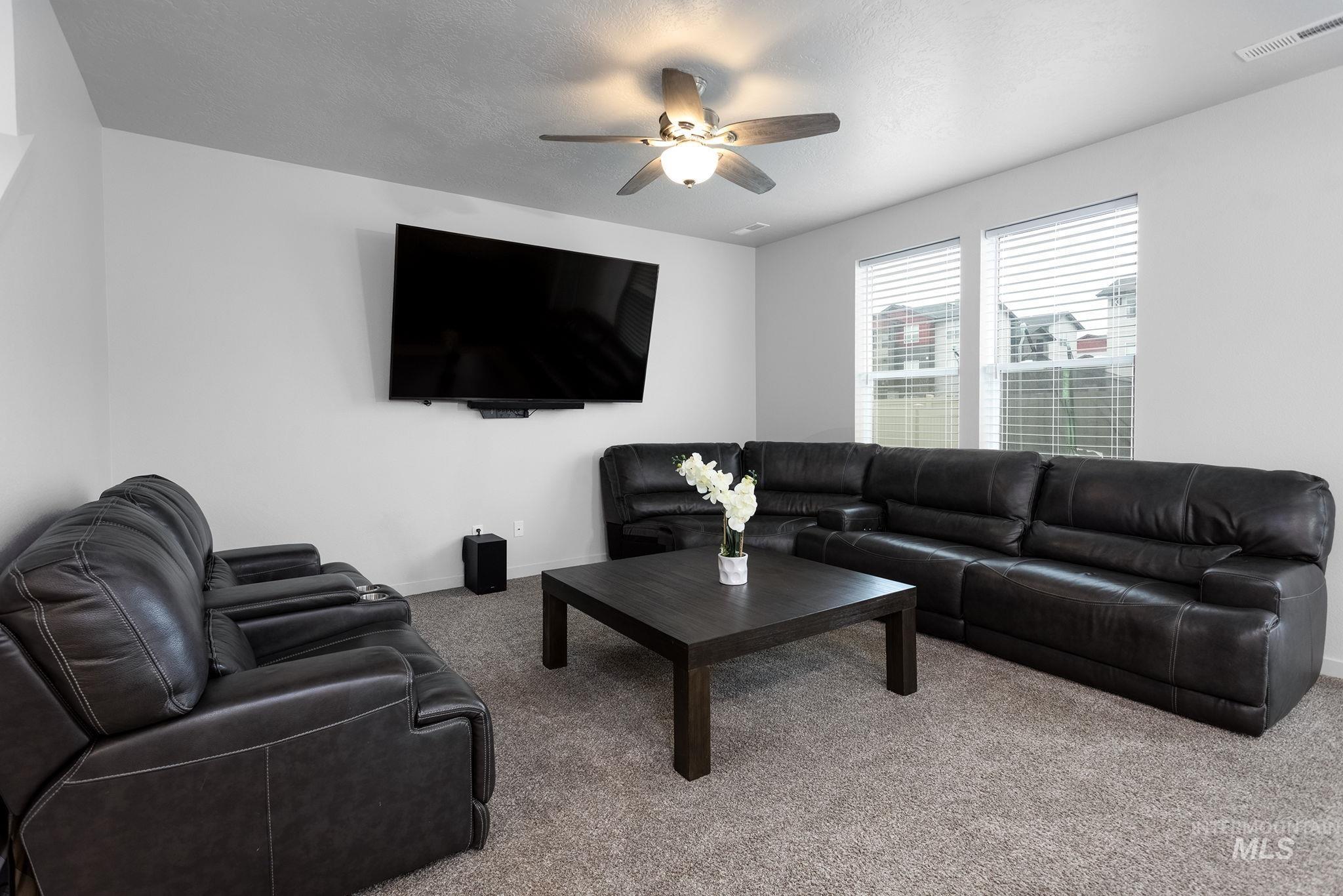 262 South Riggs Spg Avenue Meridian, ID 83642 - Photo 8 of 25 Living area featuring carpet floors and ceiling fan