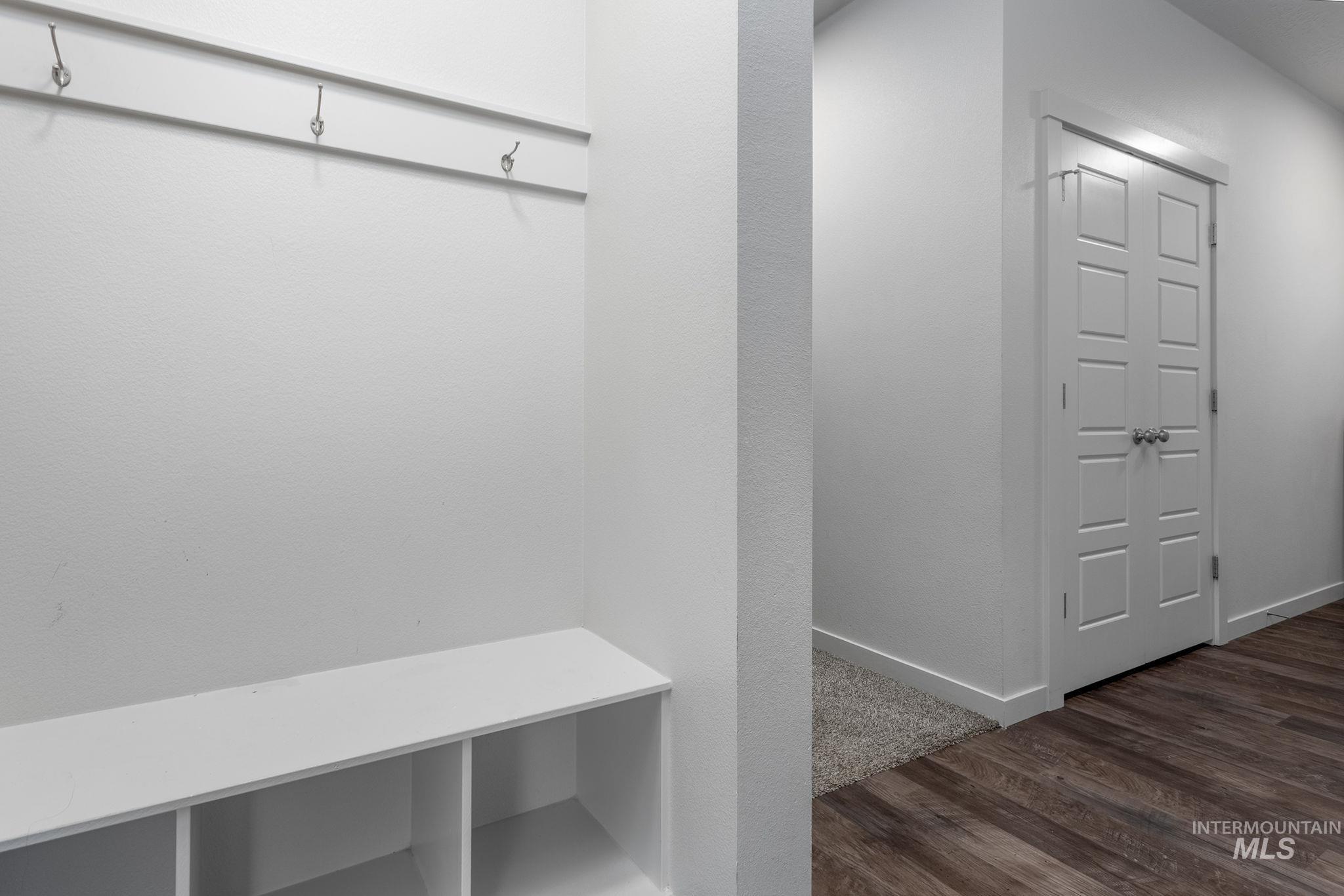 262 South Riggs Spg Avenue Meridian, ID 83642 - Photo 9 of 25 Mudroom featuring dark wood-type flooring and baseboards