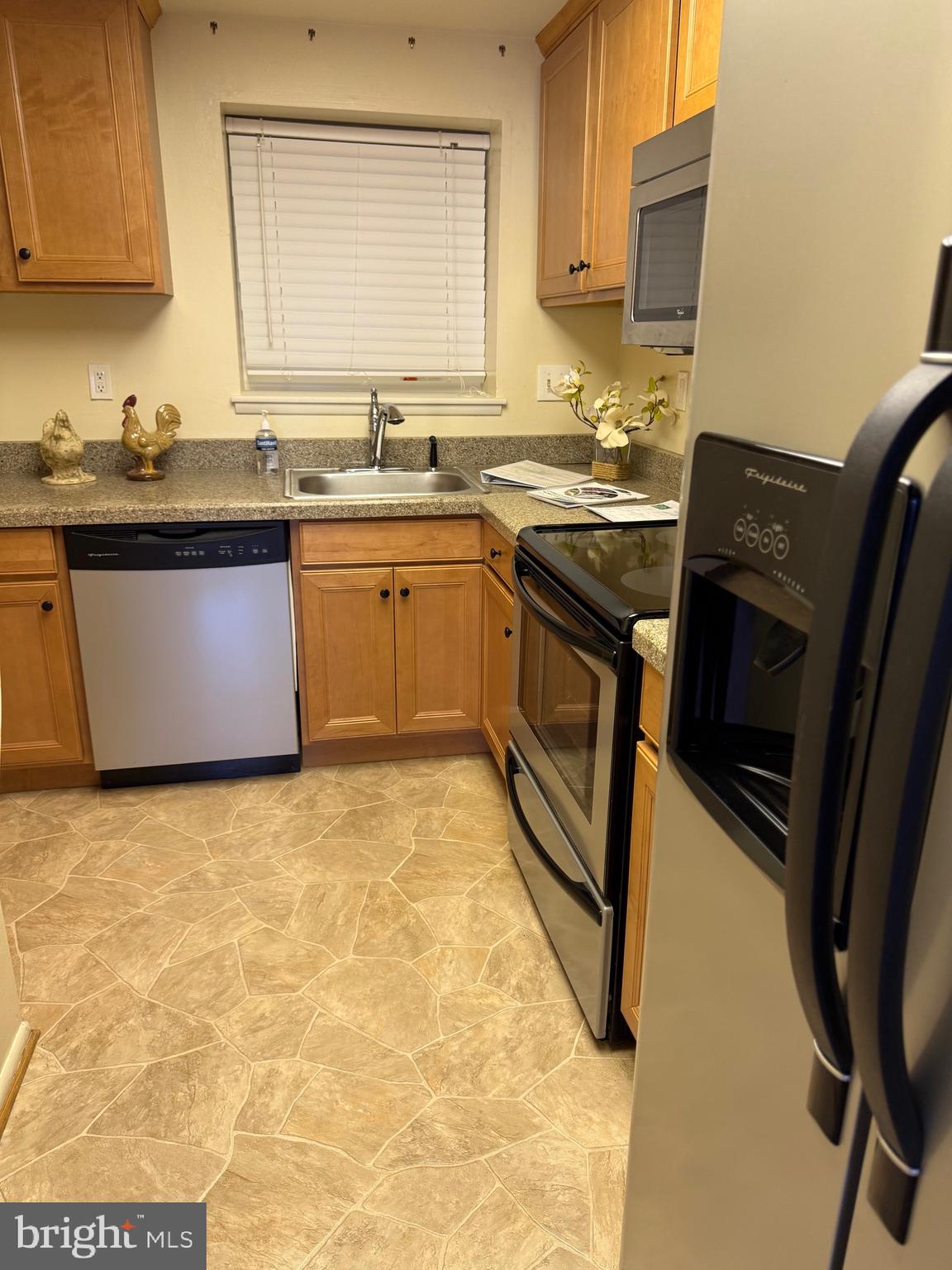 15401 Bassett Lane, Unit 452E Silver Spring, MD 20906 - Photo 18 of 31 a kitchen with stainless steel appliances granite countertop a sink stove and refrigerator