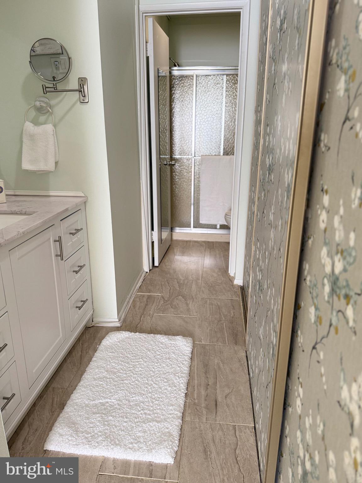 15401 Bassett Lane, Unit 452E Silver Spring, MD 20906 - Photo 22 of 31 a bathroom with a sink and mirror with bathtub