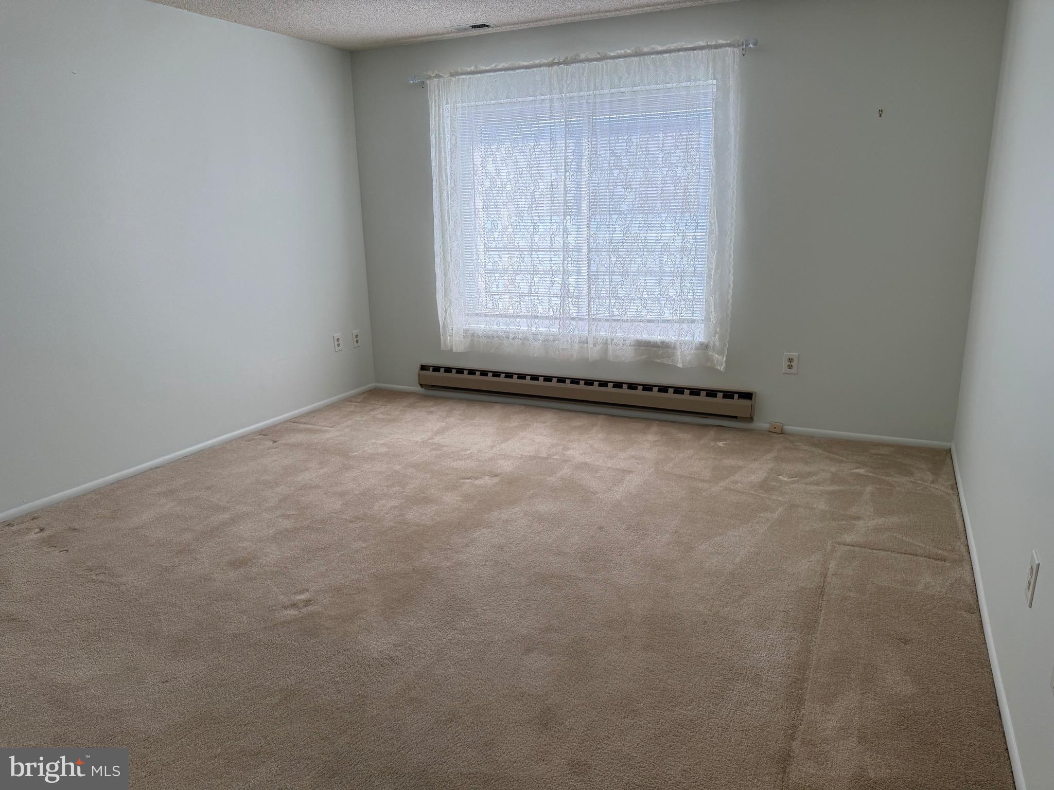 15401 Bassett Lane, Unit 452E Silver Spring, MD 20906 - Photo 25 of 31 a view of an empty room with a window