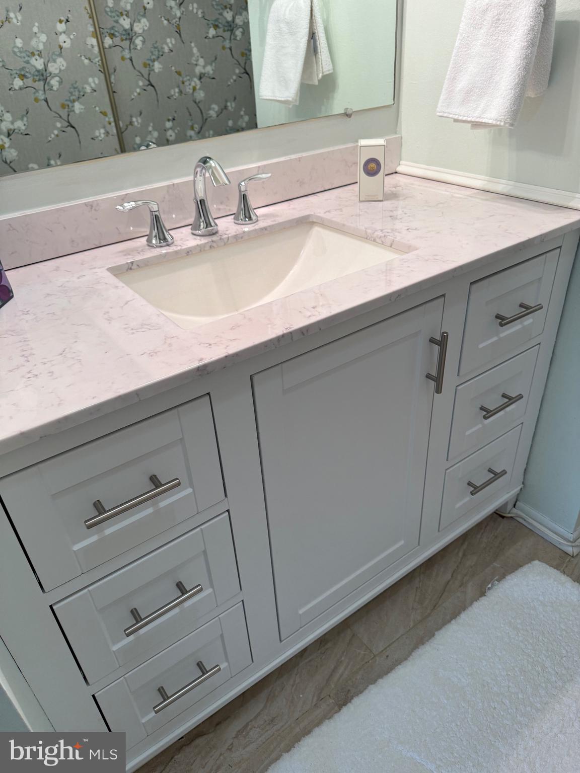 15401 Bassett Lane, Unit 452E Silver Spring, MD 20906 - Photo 28 of 31 a bathroom with a sink and a mirror