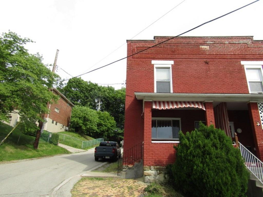 1214 1/2 3rd Street McKees Rocks, PA 15136 - Photo 1 of 28 a front view of a house with garden