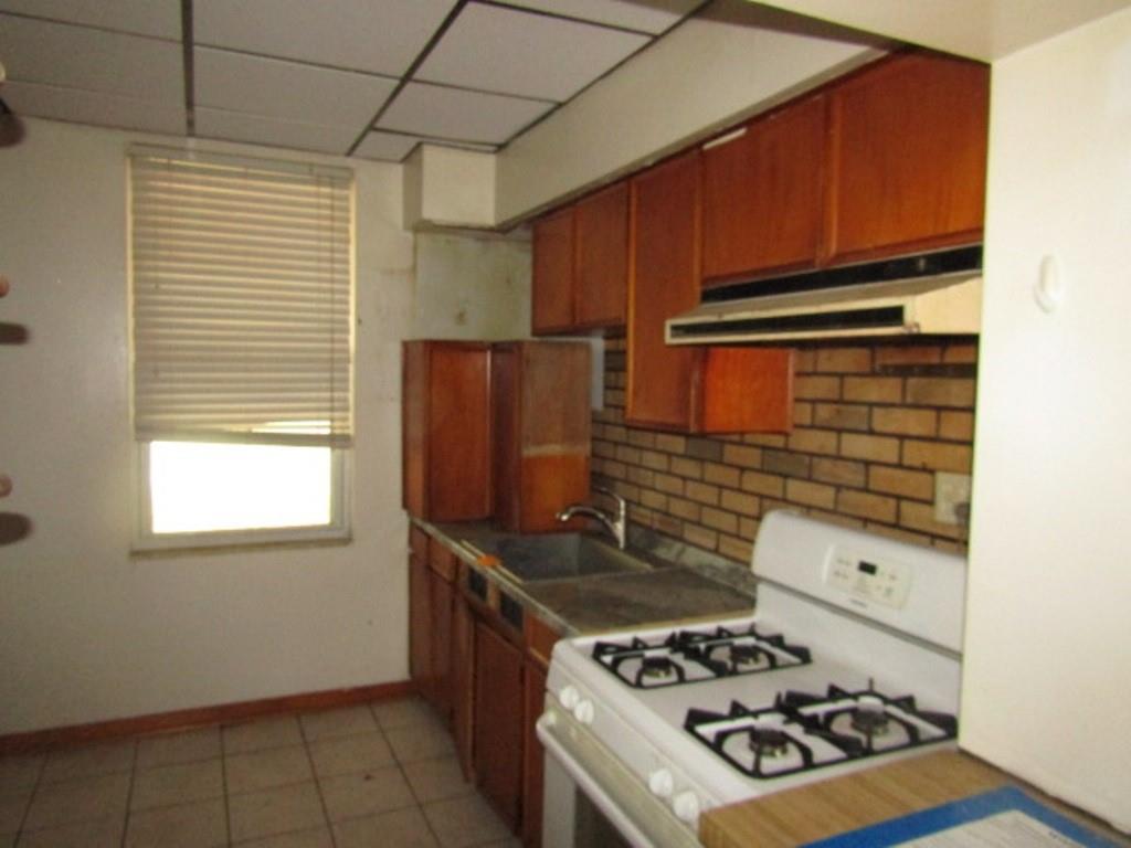 1214 1/2 3rd Street McKees Rocks, PA 15136 - Photo 11 of 28 a kitchen with a stove a refrigerator and a window