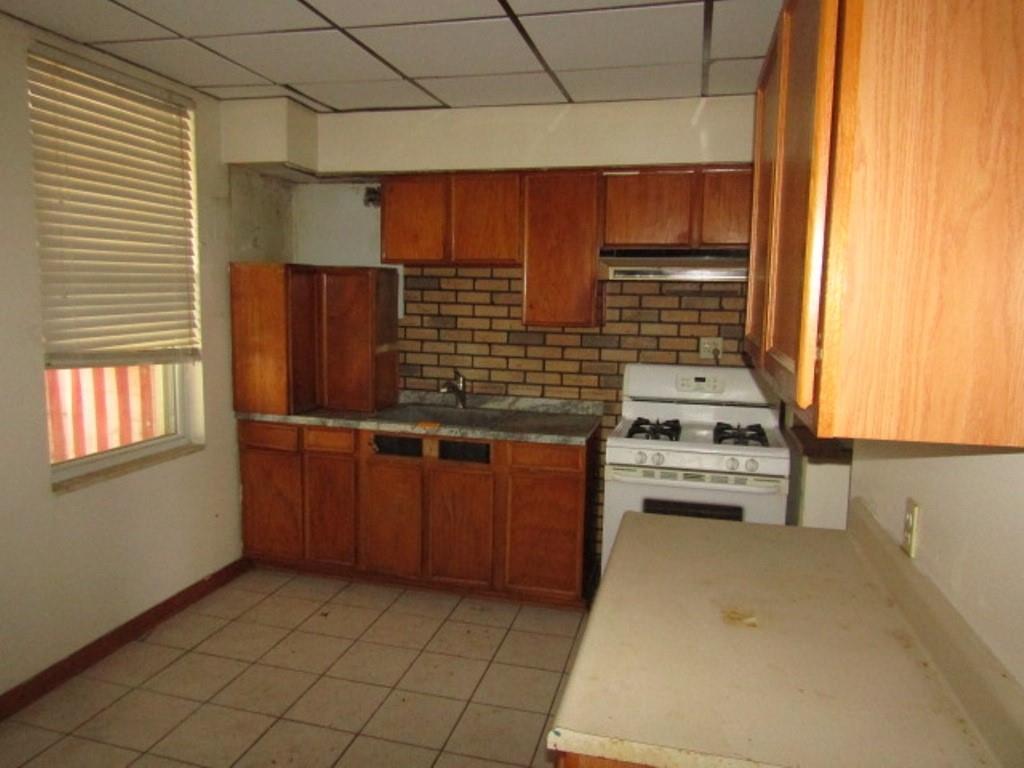 1214 1/2 3rd Street McKees Rocks, PA 15136 - Photo 13 of 28 a kitchen with stainless steel appliances a stove and a refrigerator