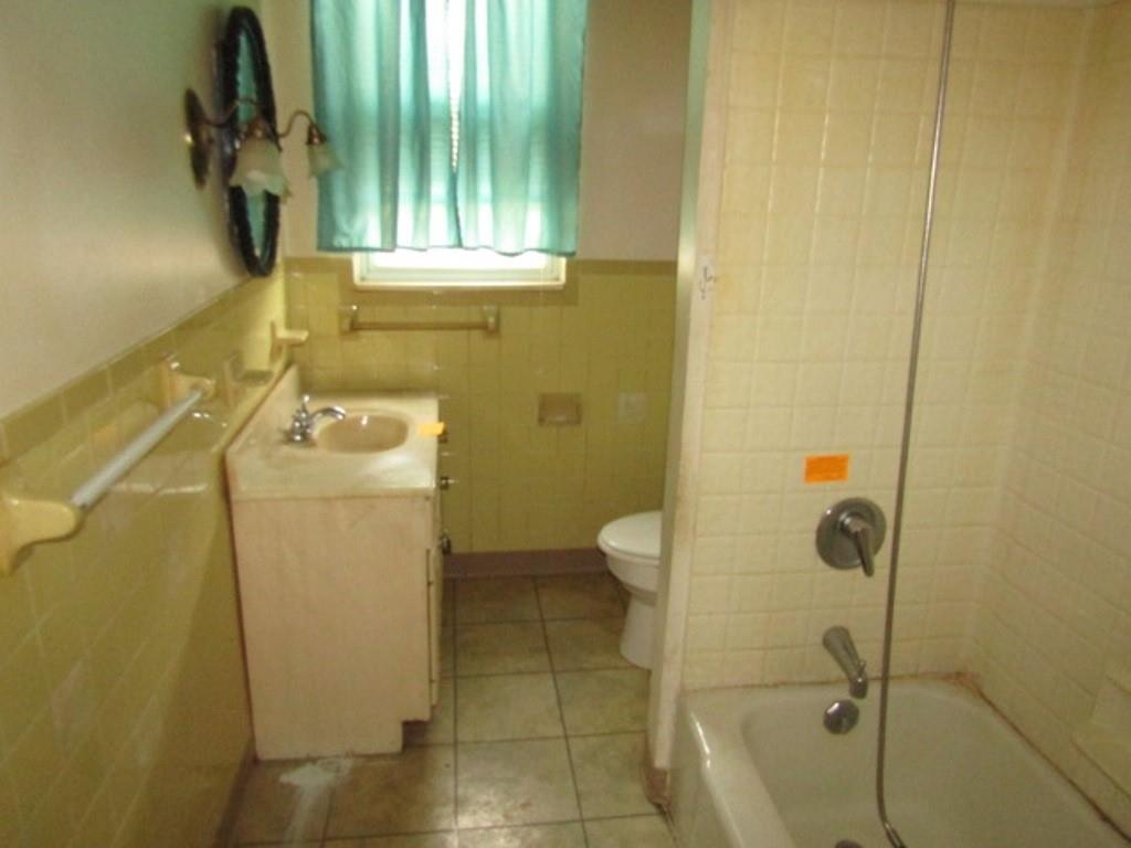 1214 1/2 3rd Street McKees Rocks, PA 15136 - Photo 14 of 28 a bathroom with a granite countertop sink a toilet and shower