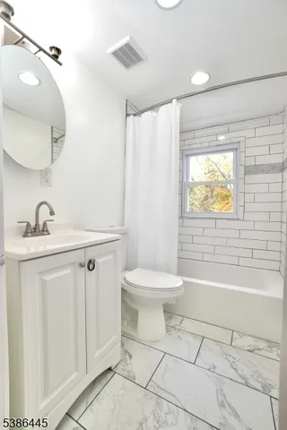 a bathroom with a sink a toilet and bathtub