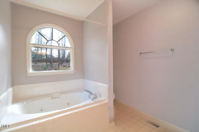 a white bath tub sitting next to a window