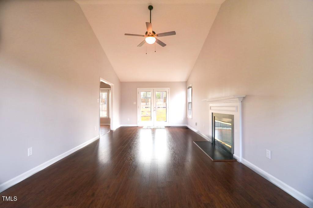 6400 Westborough Drive Raleigh, NC 27612 - Photo 2 of 15 an empty room with wooden floor fan and windows