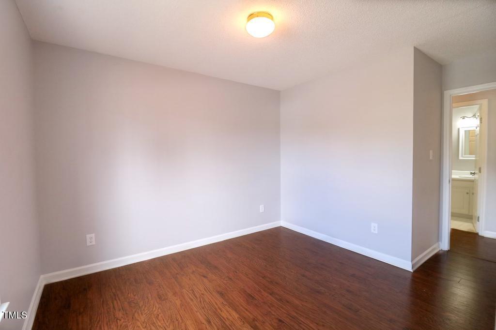 6400 Westborough Drive Raleigh, NC 27612 - Photo 4 of 15 a view of an empty room with wooden floor and a window