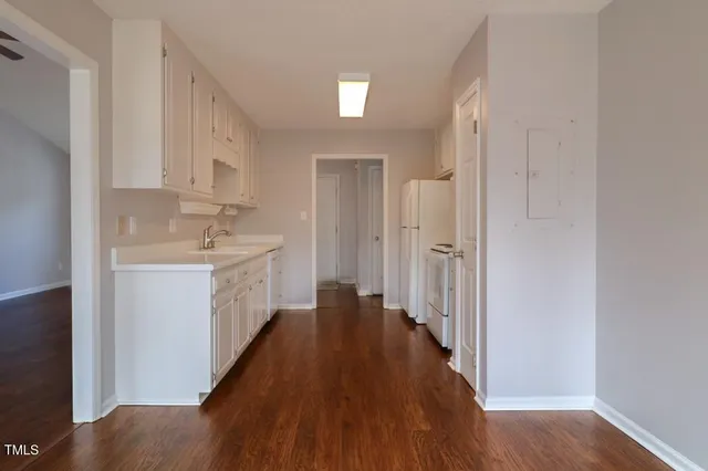 a view of a hallway with wooden floor and closet