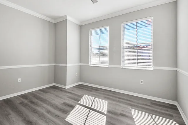 a view of a room with wooden floor and windows