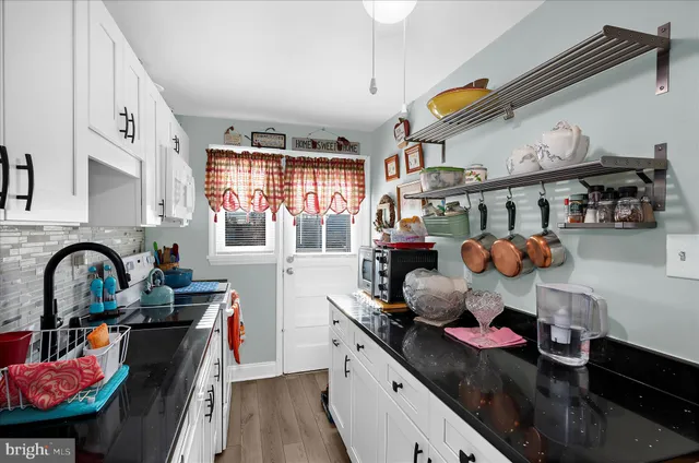 a kitchen with stainless steel appliances granite countertop a stove and a sink