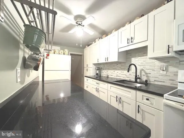 a kitchen with granite countertop a sink stainless steel appliances and cabinets