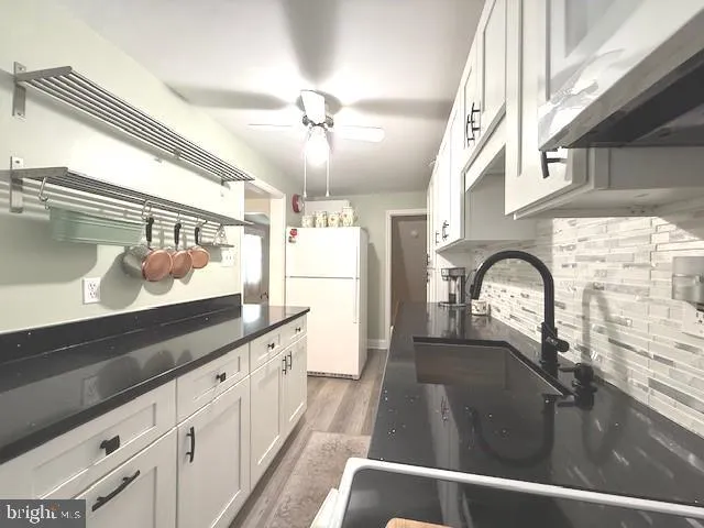 a view of a kitchen with a sink and cabinets