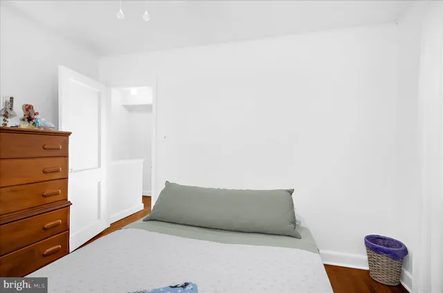 a bedroom with a bed and a dresser